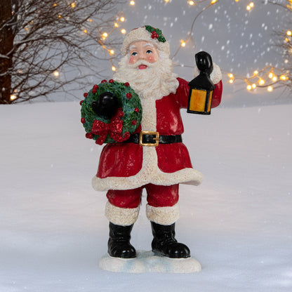Weihnachtsmann mit Kranz und Laterne
